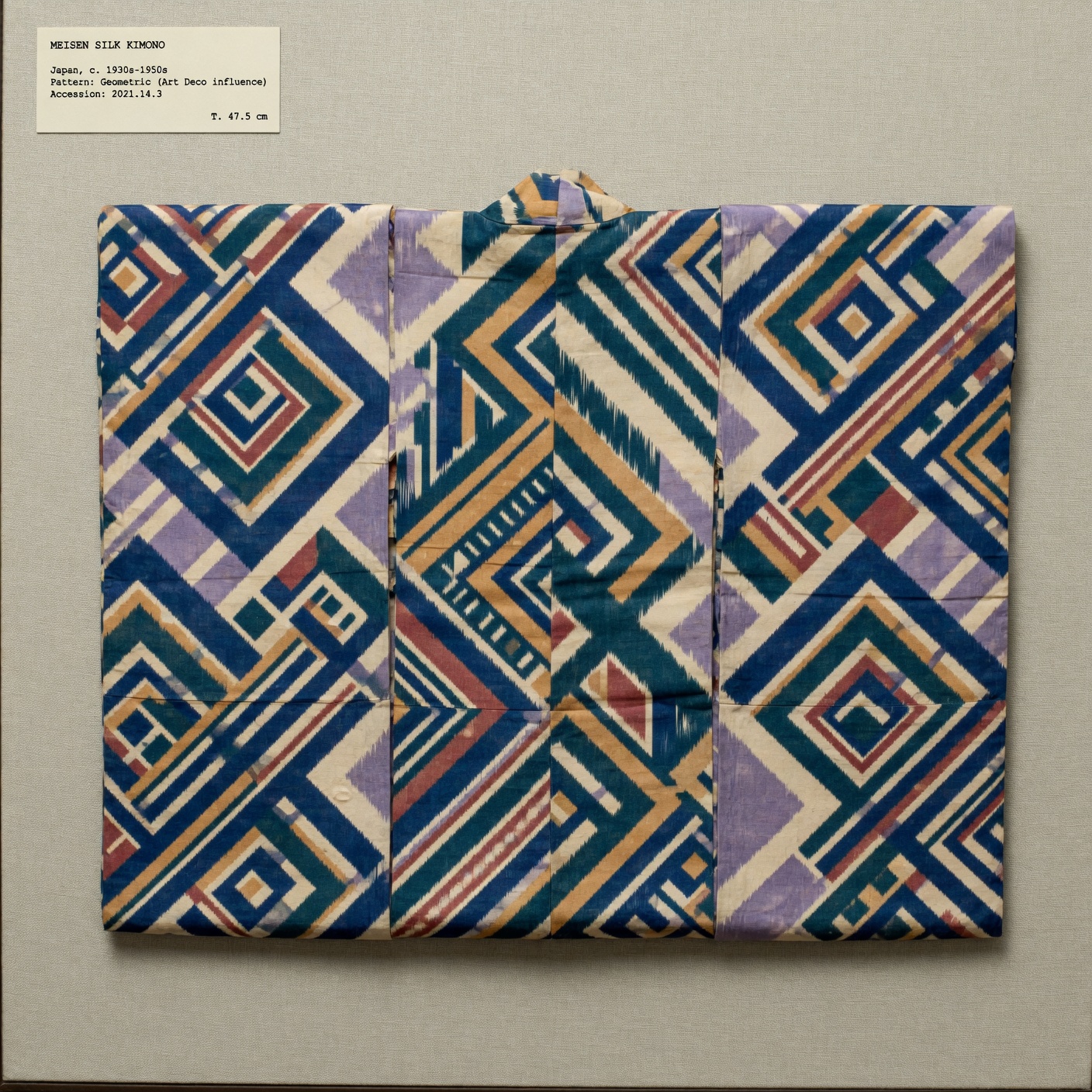 Vintage meisen silk kimono with bold geometric Art Deco pattern displayed flat and photographed from above to show the full textile design.
