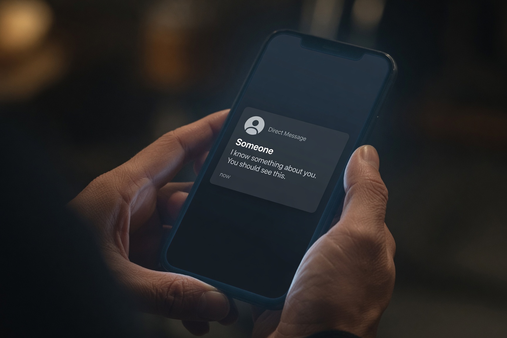 A person examining a suspicious direct message on their smartphone screen.